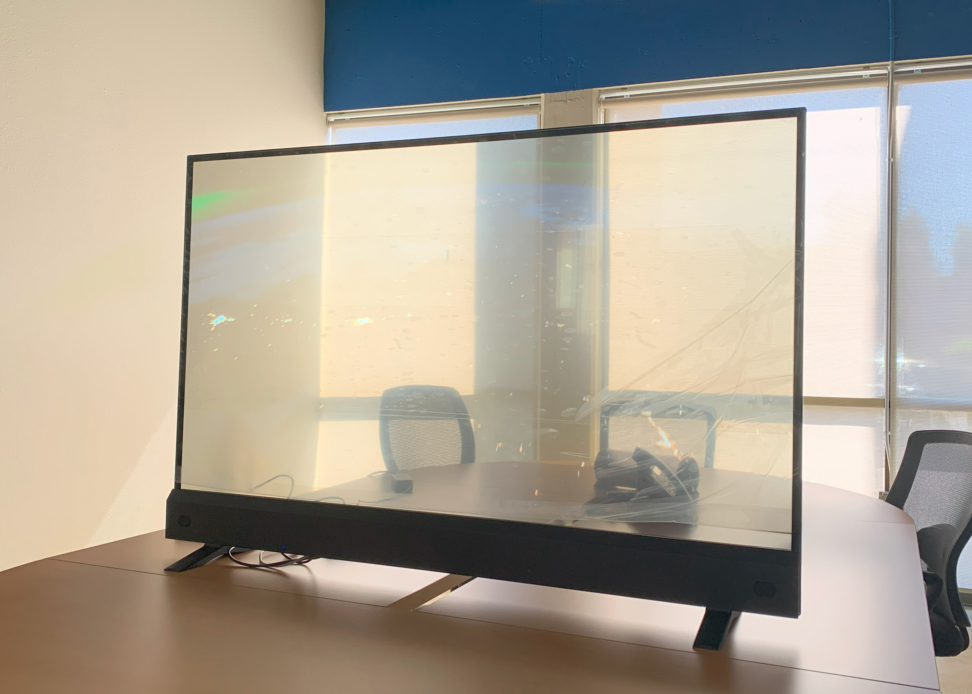Transparent OLED screen on a table in an office